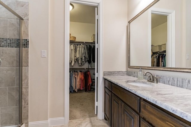 bathroom with vanity and a shower with door