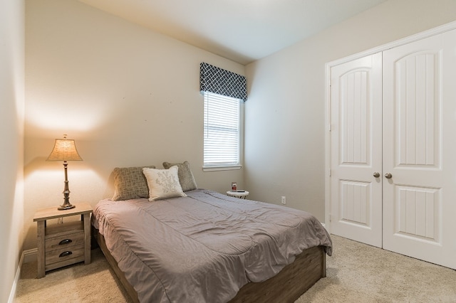 carpeted bedroom featuring a closet