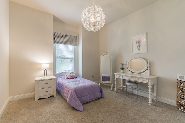 carpeted bedroom featuring a chandelier