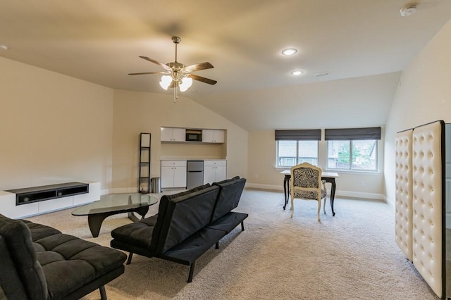 living room featuring lofted ceiling, light colored carpet, and ceiling fan