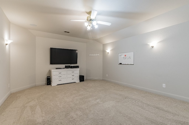 unfurnished living room featuring light carpet, lofted ceiling, and ceiling fan