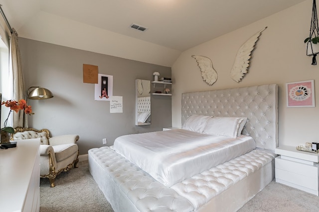 bedroom featuring vaulted ceiling and light colored carpet