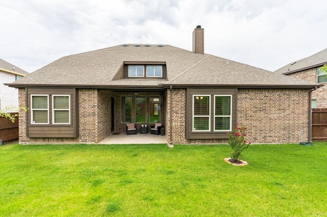 back of house with a patio area and a lawn