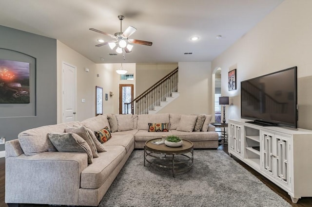 living room featuring dark wood-type flooring, plenty of natural light, and ceiling fan