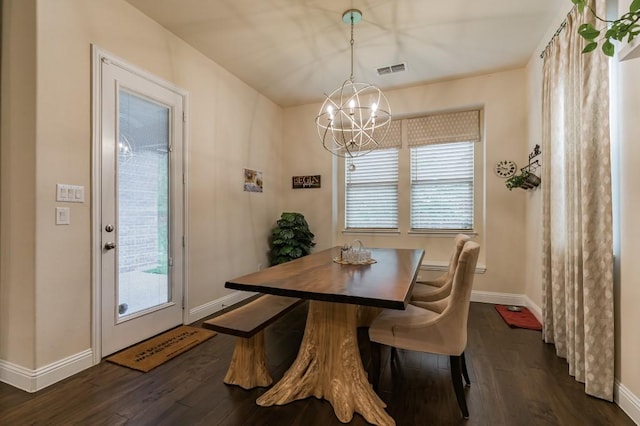 dining room with dark hardwood / wood-style flooring and a notable chandelier