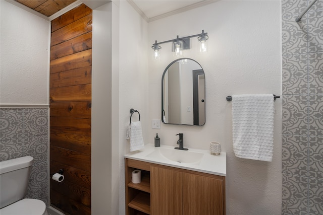 bathroom featuring ornamental molding, vanity, and toilet