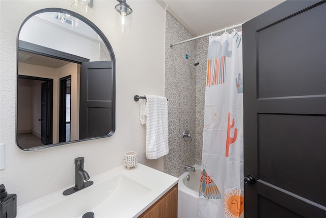 bathroom with shower / tub combo and vanity