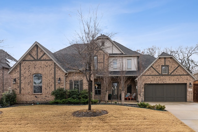 view of front of property featuring a front lawn, a garage, brick siding, and driveway