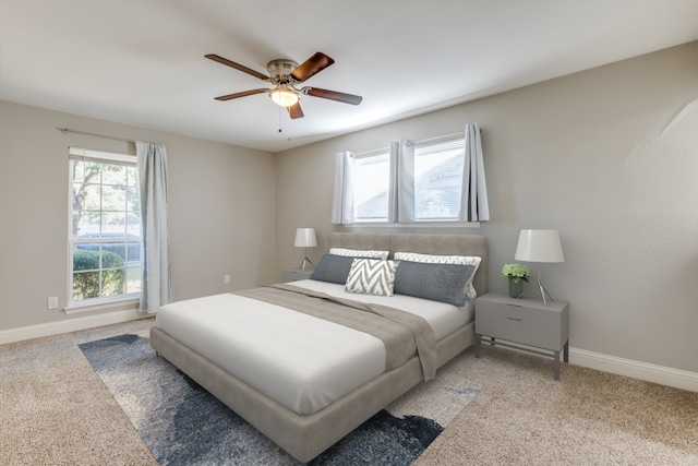 carpeted bedroom with multiple windows and ceiling fan