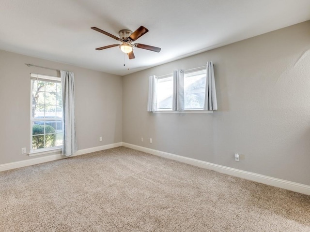 empty room with ceiling fan and carpet