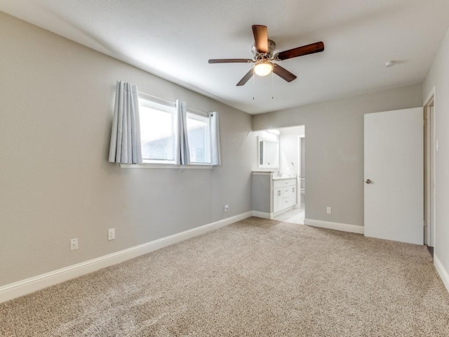 unfurnished bedroom with light carpet, ceiling fan, and ensuite bathroom