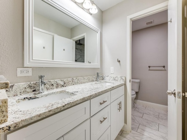 bathroom with vanity and toilet