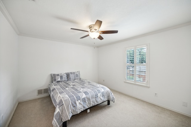 carpeted bedroom with crown molding and ceiling fan