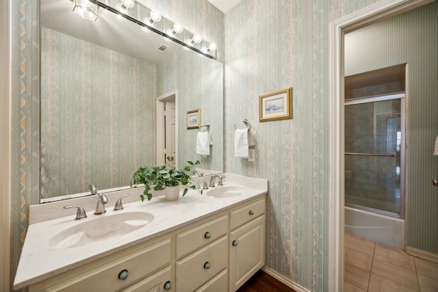 bathroom featuring vanity, tile patterned flooring, and shower / bath combination with glass door