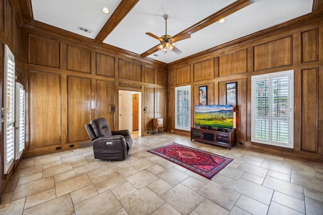 unfurnished room with ceiling fan, beam ceiling, and wood walls