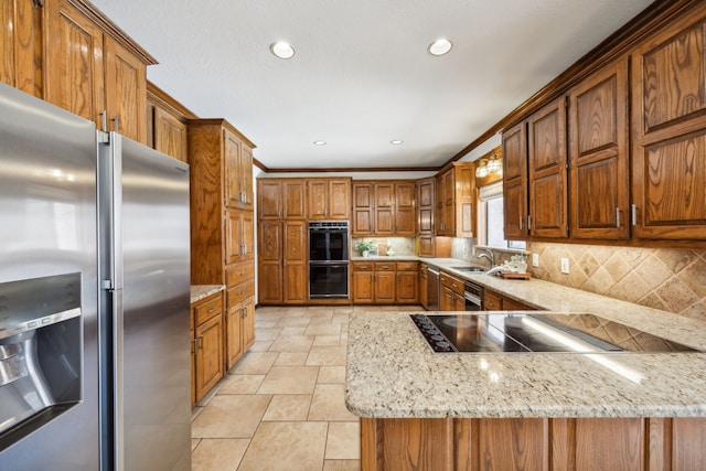 kitchen featuring backsplash, sink, light stone counters, and black appliances