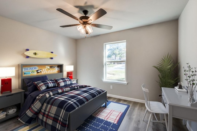 bedroom with dark hardwood / wood-style floors and ceiling fan