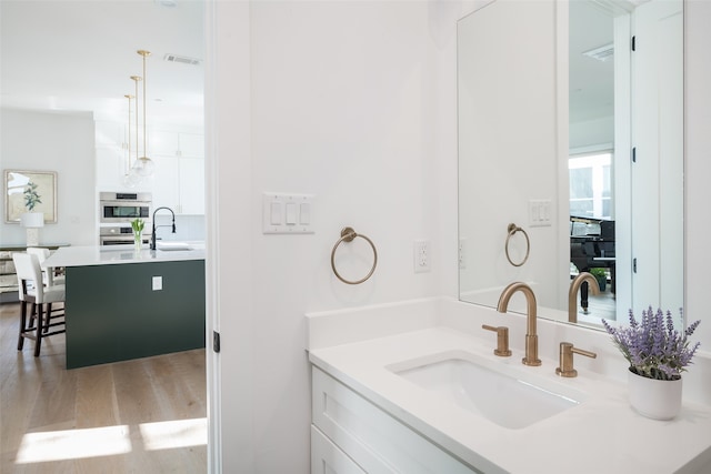 bathroom with vanity and hardwood / wood-style floors