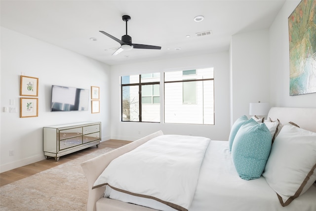 bedroom with ceiling fan and light wood-type flooring