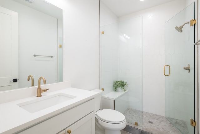 bathroom with a shower with door, vanity, and toilet