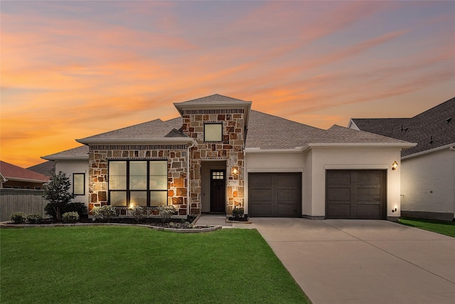 prairie-style house with a garage and a yard