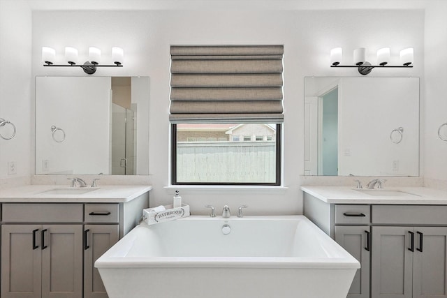 bathroom with vanity and separate shower and tub