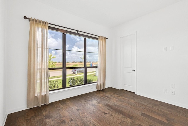 empty room featuring dark wood-type flooring