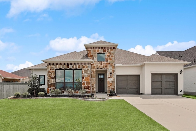 view of front of house with a garage and a front lawn