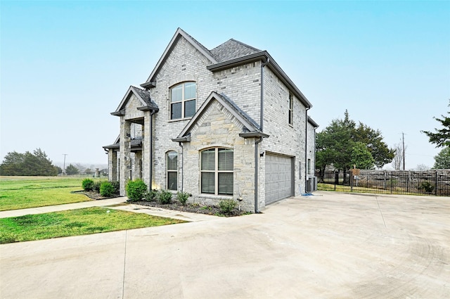 french country style house featuring central AC, a garage, and a front yard