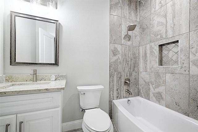 full bathroom with tiled shower / bath, vanity, and toilet