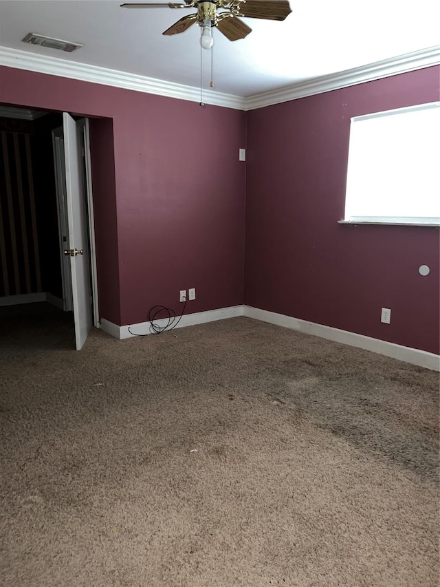 carpeted empty room featuring crown molding and ceiling fan