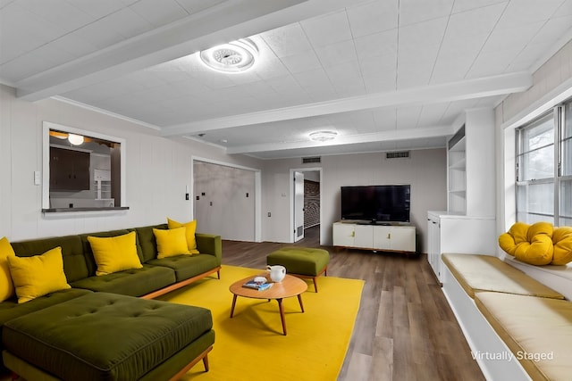 living room featuring beamed ceiling and hardwood / wood-style flooring