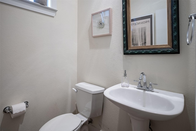 bathroom with toilet and sink