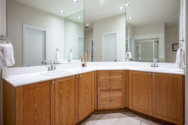 bathroom with tile patterned flooring, vanity, and walk in shower