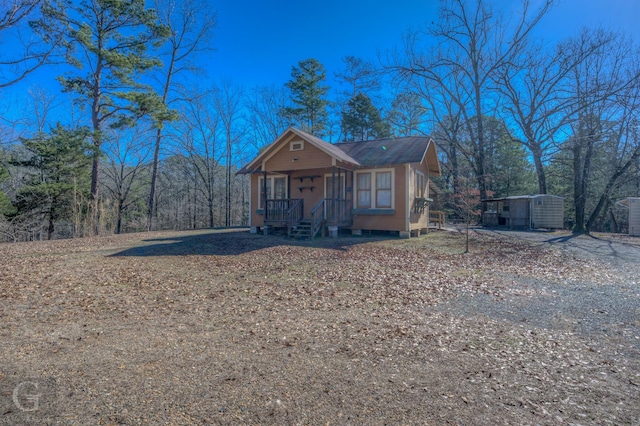 bungalow with a porch and a storage unit