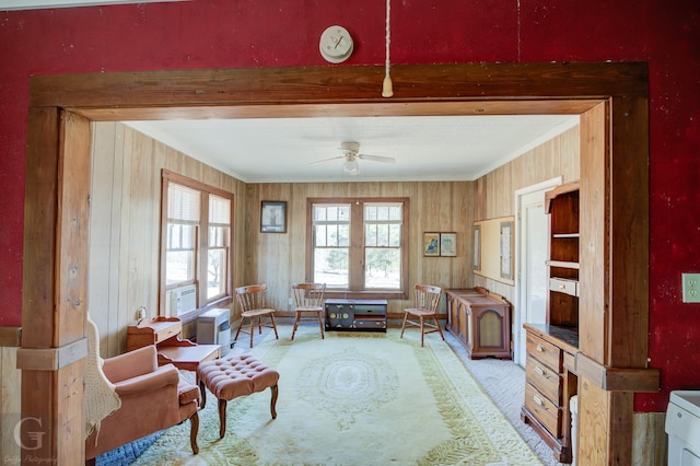 sitting room with crown molding, carpet, and ceiling fan