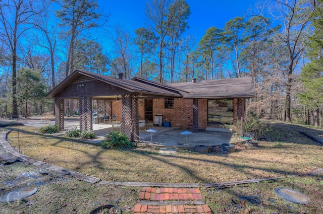 view of front of house with a patio and a front yard