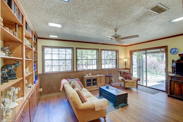 interior space featuring crown molding, hardwood / wood-style floors, and a textured ceiling