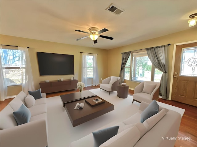 living room featuring ceiling fan and hardwood / wood-style floors