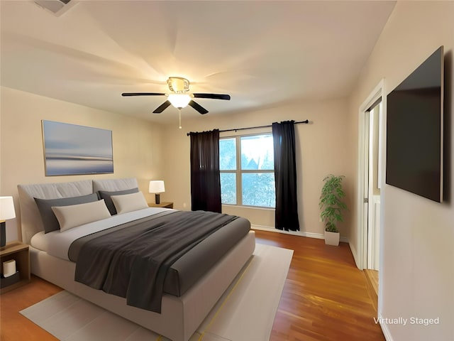 bedroom featuring light hardwood / wood-style floors and ceiling fan