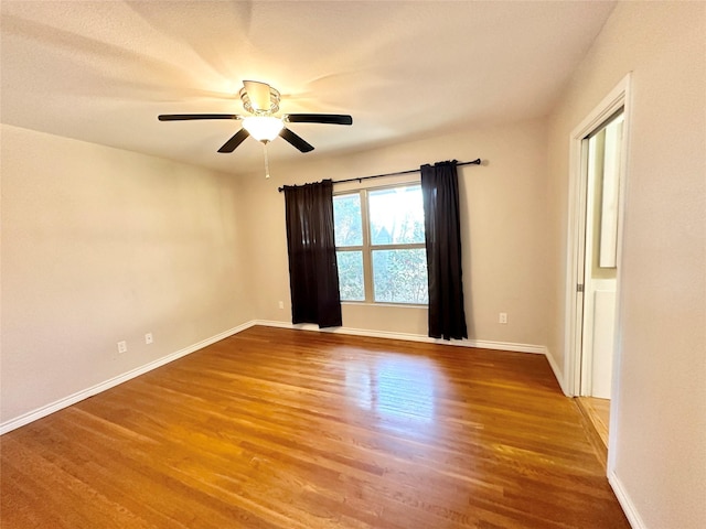 empty room featuring hardwood / wood-style floors and ceiling fan