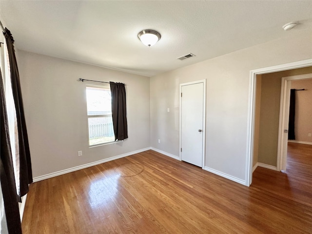 unfurnished bedroom with wood-type flooring