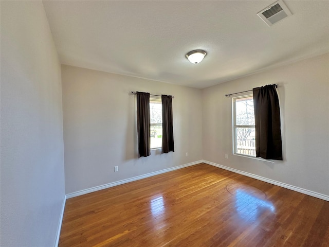 unfurnished room with hardwood / wood-style floors