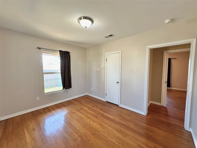 unfurnished bedroom featuring hardwood / wood-style floors