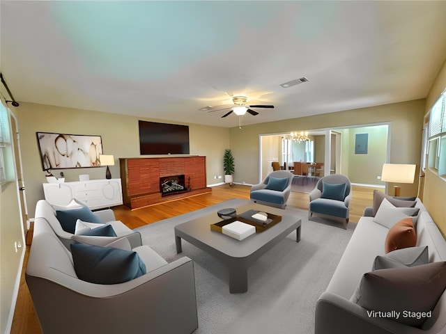 living room with wood-type flooring and a notable chandelier