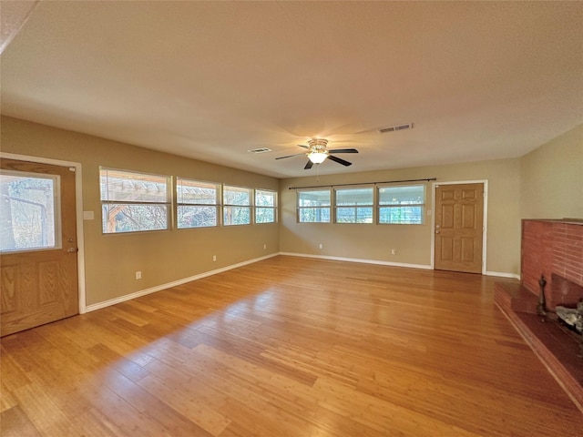 unfurnished living room with hardwood / wood-style flooring and ceiling fan