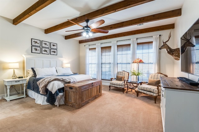 carpeted bedroom with beamed ceiling and ceiling fan