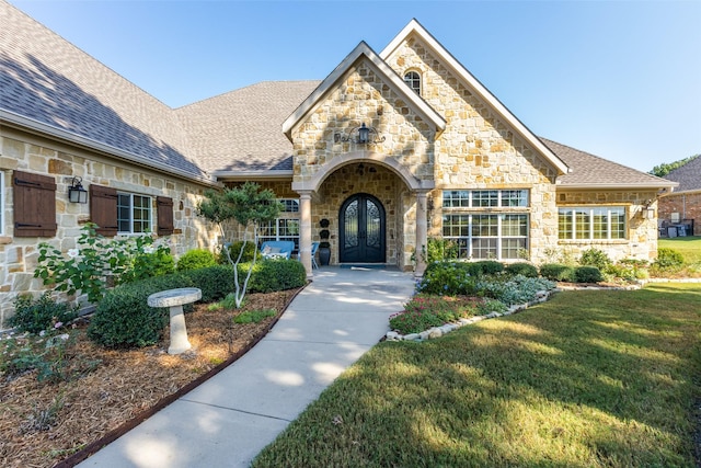 view of front of house with a front yard and french doors