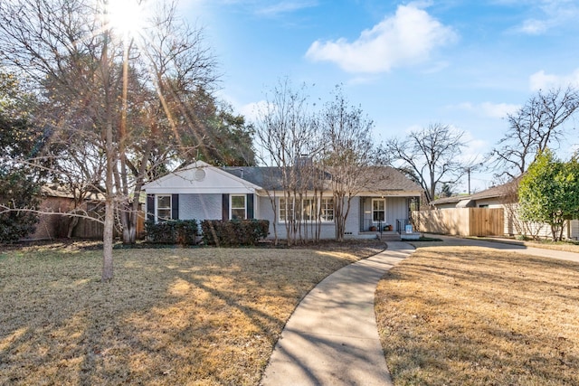 ranch-style house with a porch and a front yard