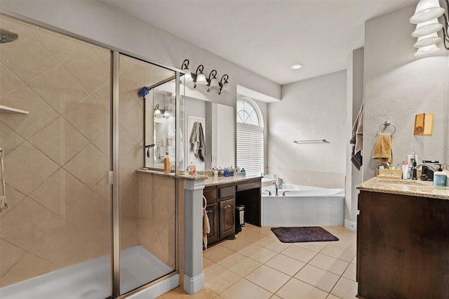 bathroom with independent shower and bath, vanity, and tile patterned flooring